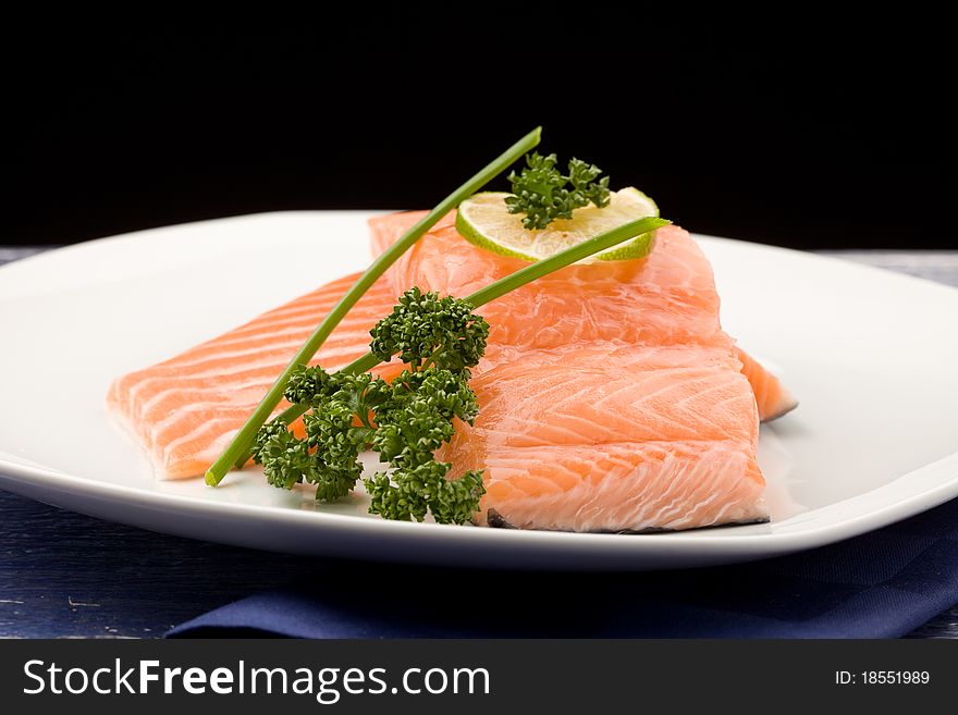 Photo of delicious salmon fillet with parsley and lime. Photo of delicious salmon fillet with parsley and lime