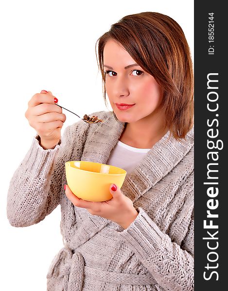 Portrait of young smiling woman eating muesli or cornflakes, isolated on white background