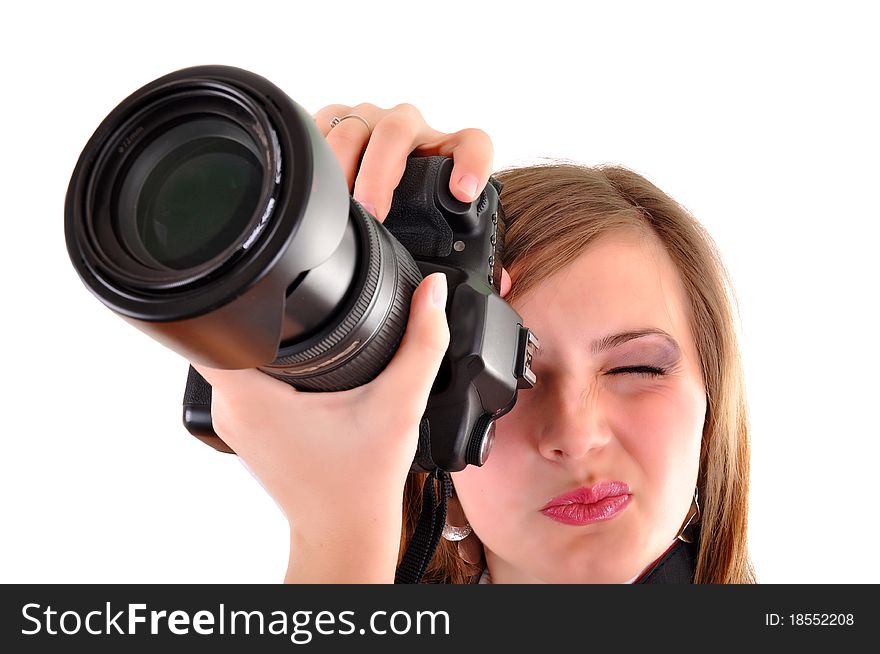 Young woman with photographic camera on white background
