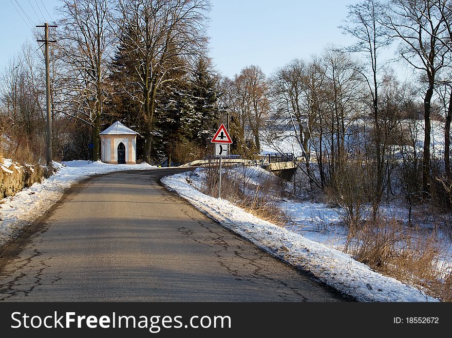 Winter road on a sunny frosty day with blue sky