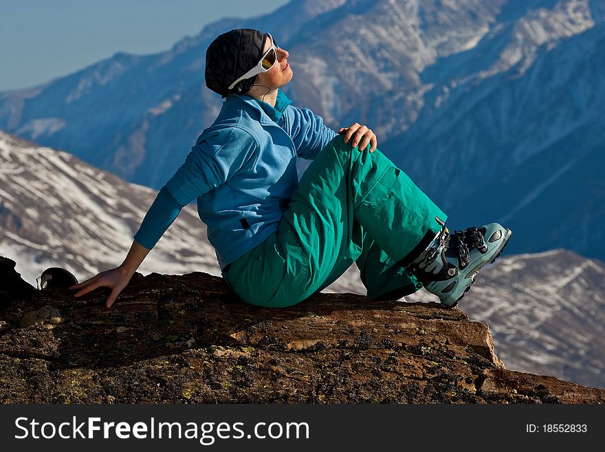 Young woman on the top of the mountain