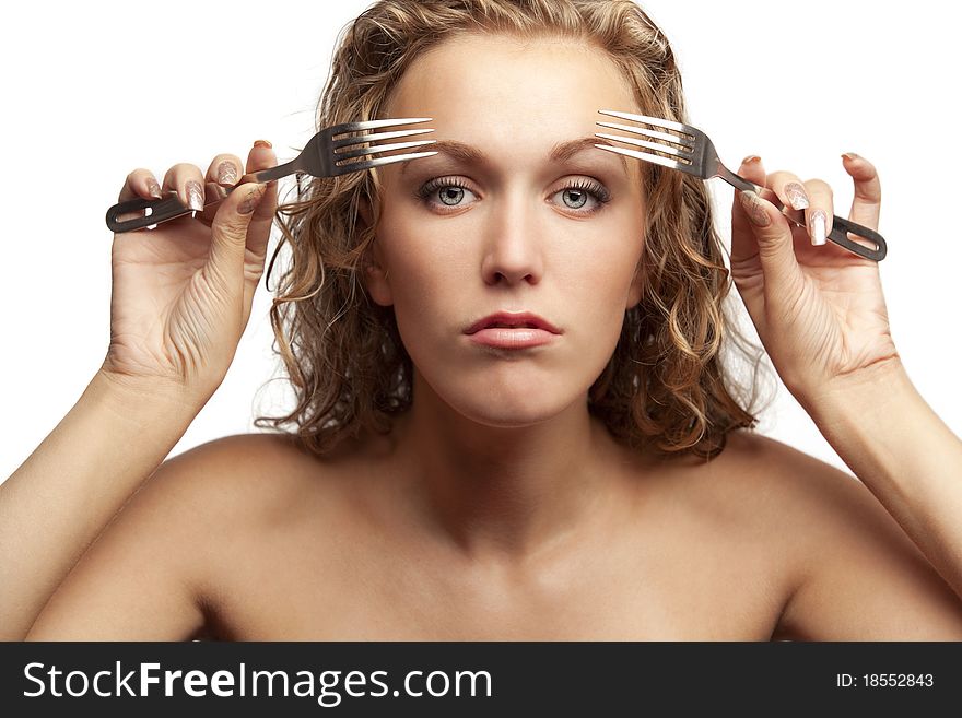 Portrait of a pretty young female looking through forks