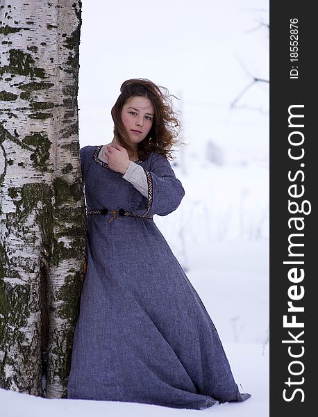 Young girl in medieval dress and the tree in winter time. Young girl in medieval dress and the tree in winter time