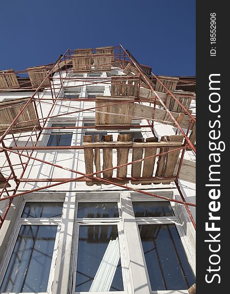 Construction. Residential building scaffolding construction background