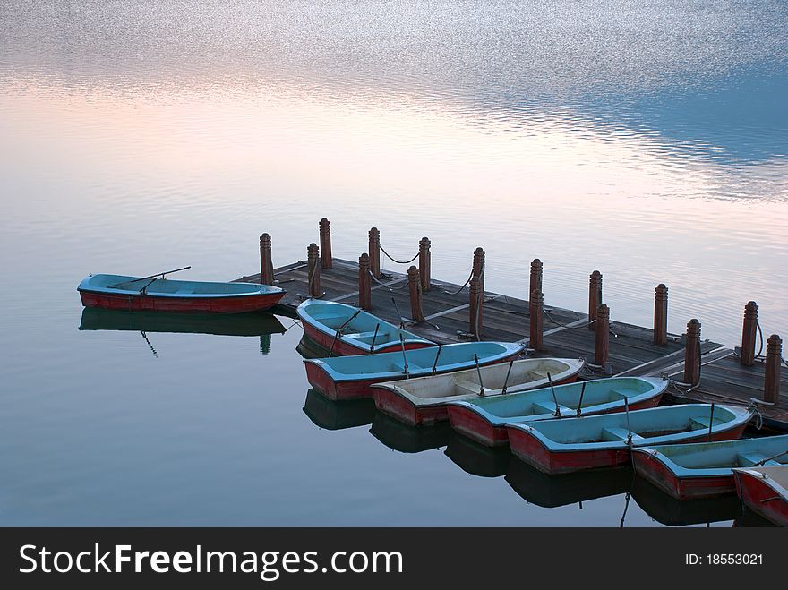 Rowboats in pier at dawn