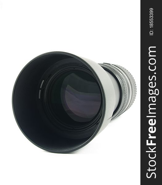 Camera lens with hood lying on the white surface