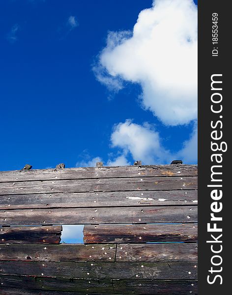 Old wooden ship fragment and sky background
