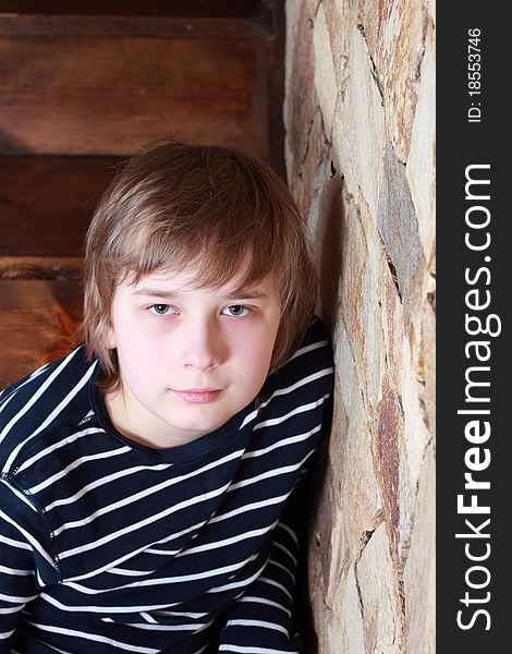 A teenager sitting on the stairs. A teenager sitting on the stairs.