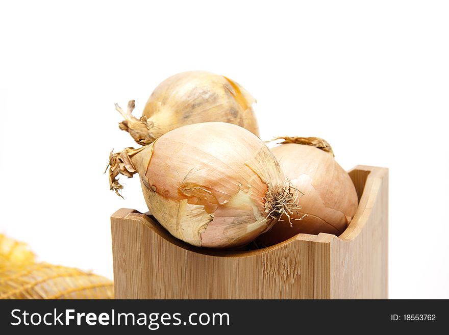 Raw onion in the wood receptacle