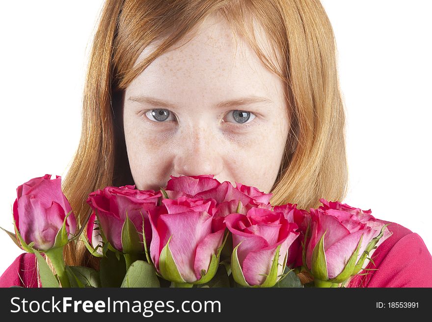 Young girl is smelling at beautiful pink roses on a white background
