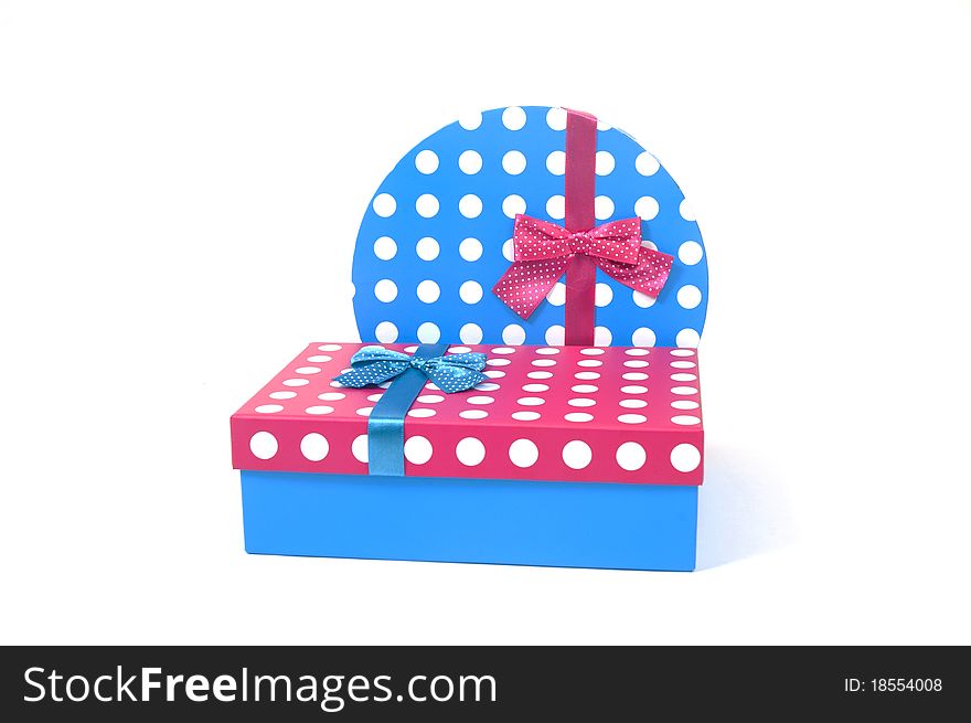 Two present decorated with dots and bows isolated on white