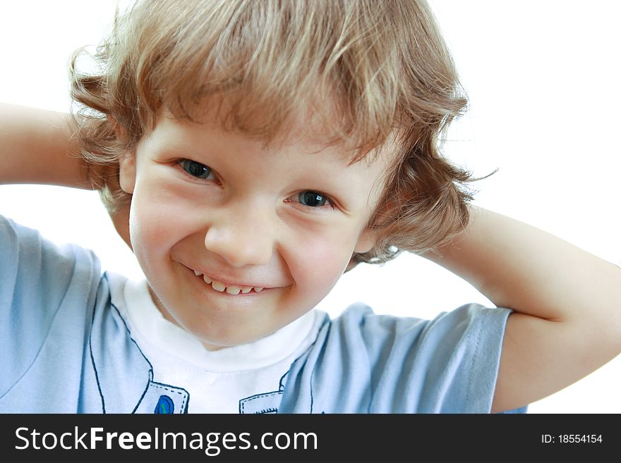 Little boy smiling and holding hands head. White background. Little boy smiling and holding hands head. White background