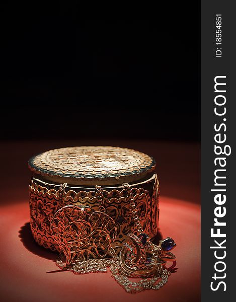 Wooden casket and adornment on black background