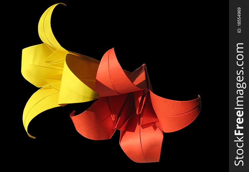 Origami red & yellow flower isolated on black