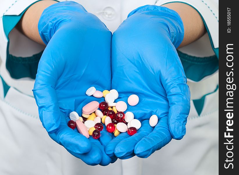 Drugs in the hands of a doctor on a white background