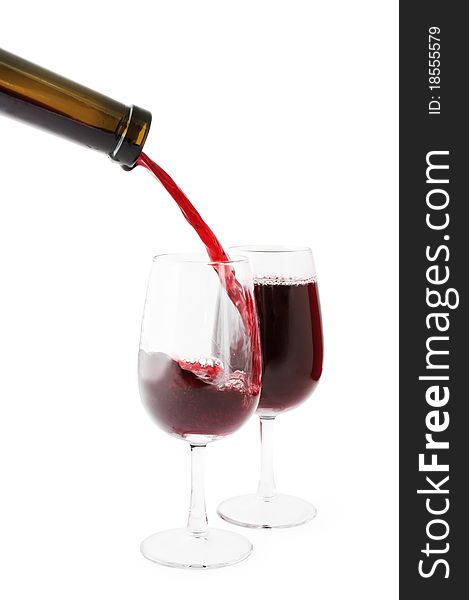 Red wine being poured into one of two glasses. Isolated on white, clipping path included. Red wine being poured into one of two glasses. Isolated on white, clipping path included.