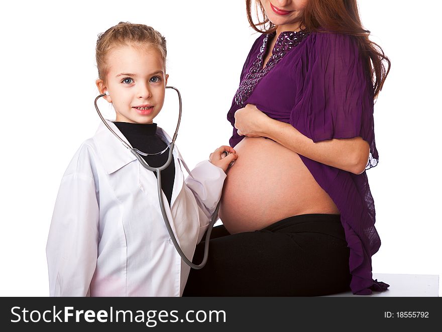 A cute girl is listening to her mother's belly. isolated on a white background