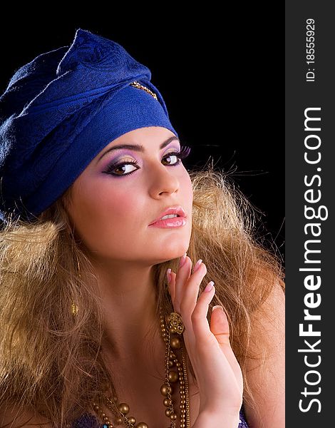 Beautiful girl in a turban and a stylized ethnic costume