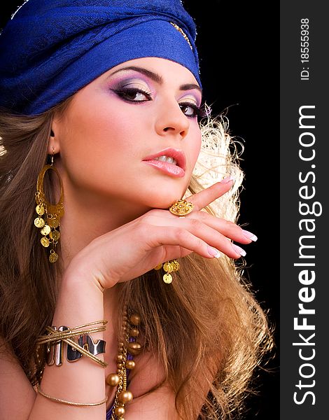 Beautiful girl in a turban and a stylized ethnic costume