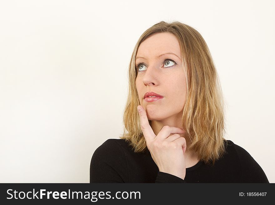 Portrait of young woman thinking and looking up