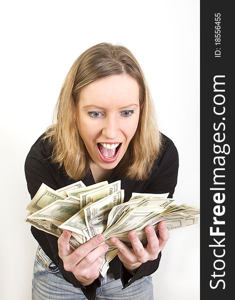 Young woman have lots of dollars in her hands and looking pleasently surprised