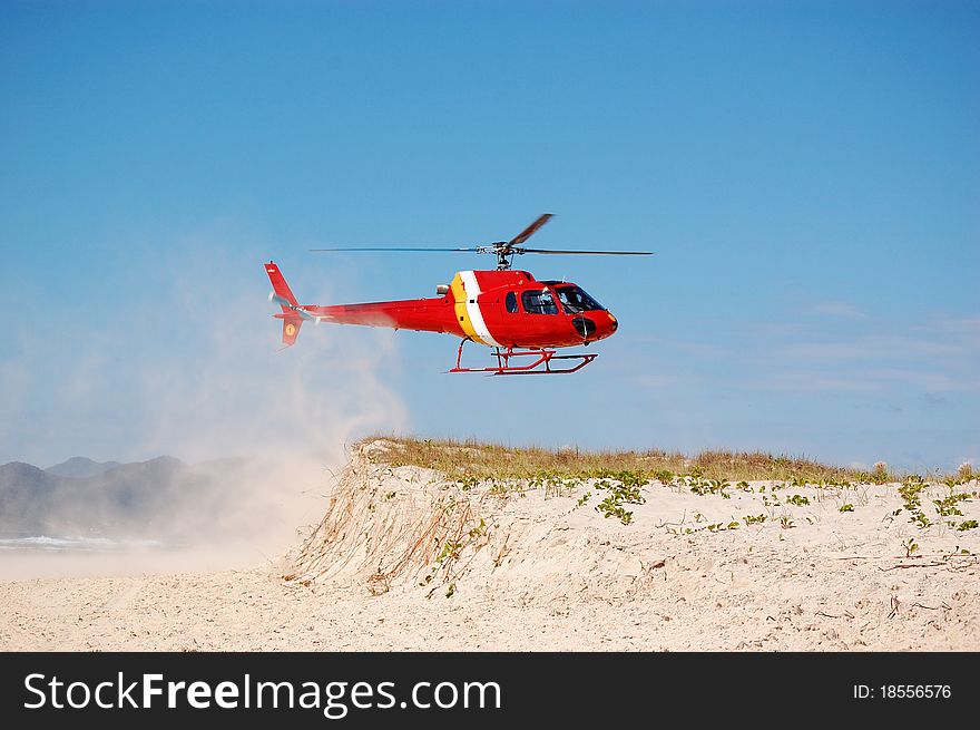 A Brazilian Coast Guard Helicopter landing at the beach. A Brazilian Coast Guard Helicopter landing at the beach