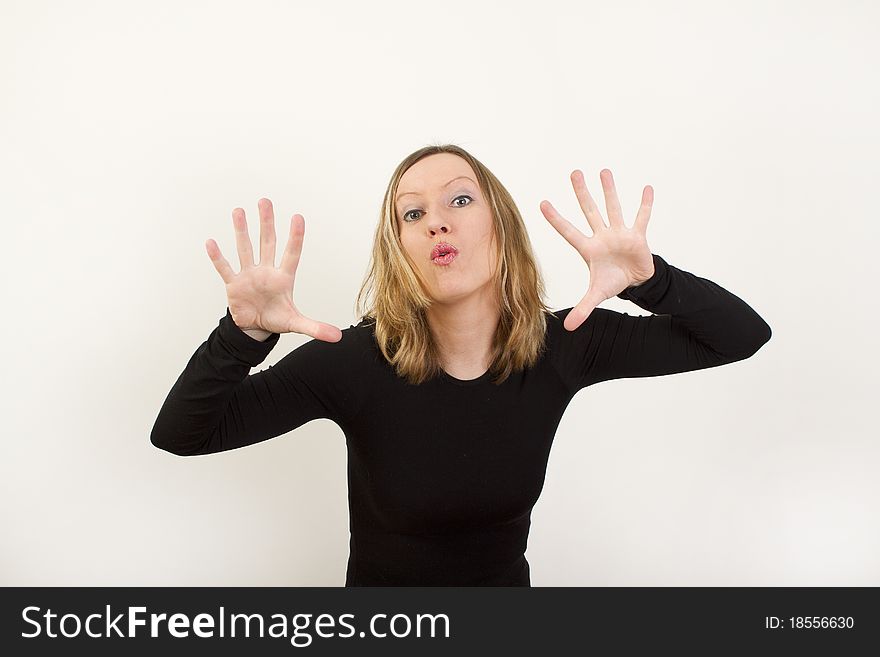 Young woman showing her palms and preparing lips for kiss. Young woman showing her palms and preparing lips for kiss