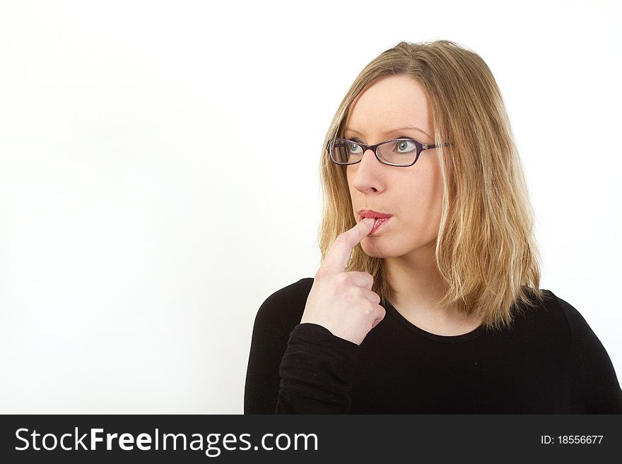 Young woman with glasses have finger in her mouth, looking somewhere and thinking, lots of copyspace