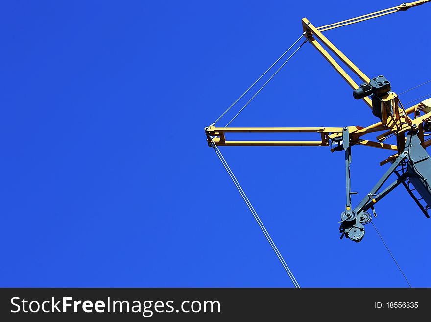 Crane holding a prefabricated element against a limpid sky. Crane holding a prefabricated element against a limpid sky