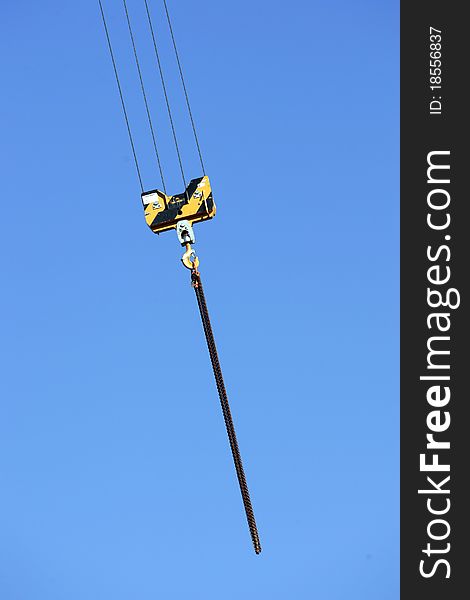 Crane holding a prefabricated element against a limpid sky. Crane holding a prefabricated element against a limpid sky