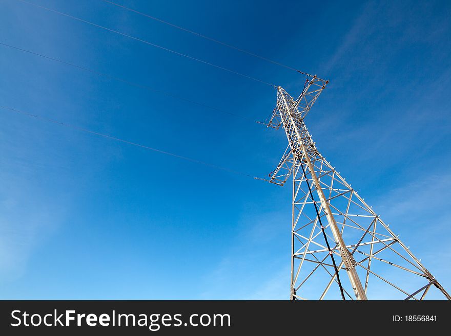 Hight voltage electrical tower against blue sky