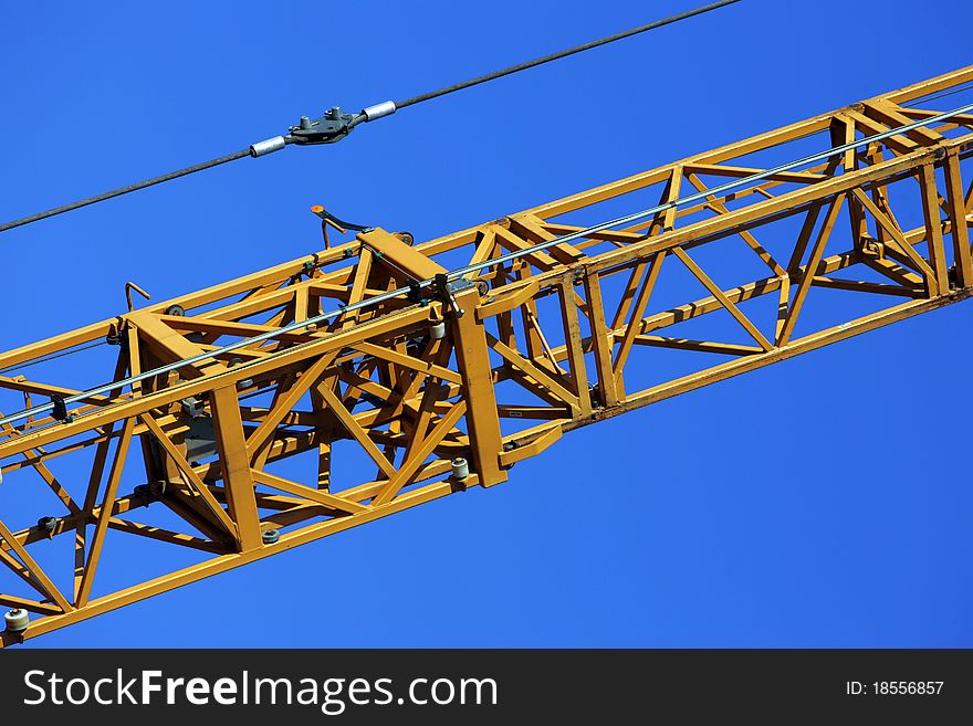 Crane holding a prefabricated element against a limpid sky. Crane holding a prefabricated element against a limpid sky