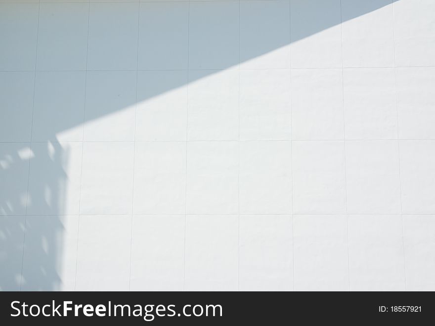 White wall with shadow creating a border at top and left. White wall with shadow creating a border at top and left.