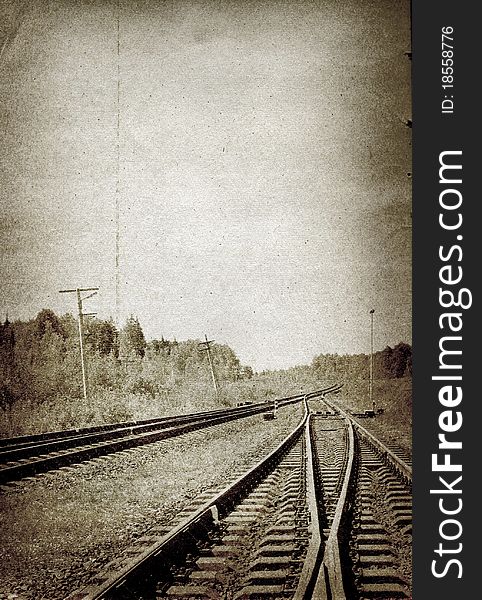Railway in the forest on grunge background