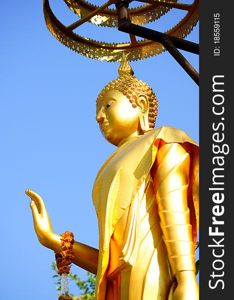 Golden Buddha statue and the blue sky