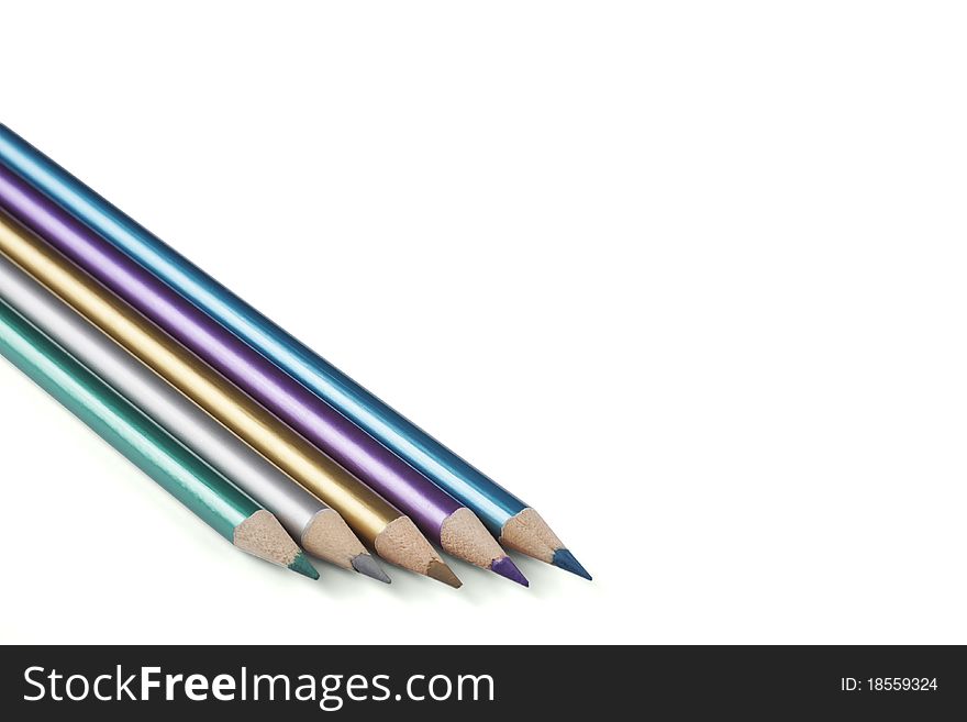 Five metalic color pencils on a white background.