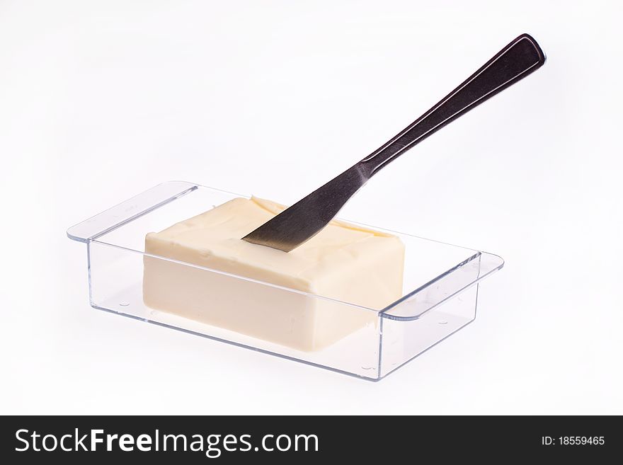 Open Block of Butter in butter dish with knife isolated over white. Open Block of Butter in butter dish with knife isolated over white