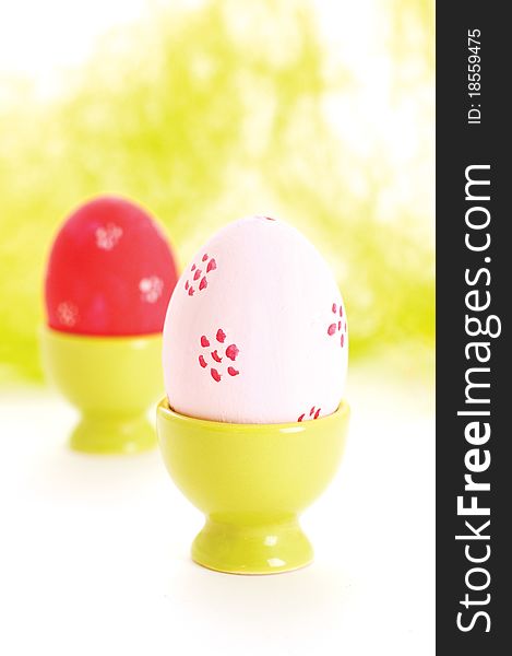Two egg cups with easter eggs