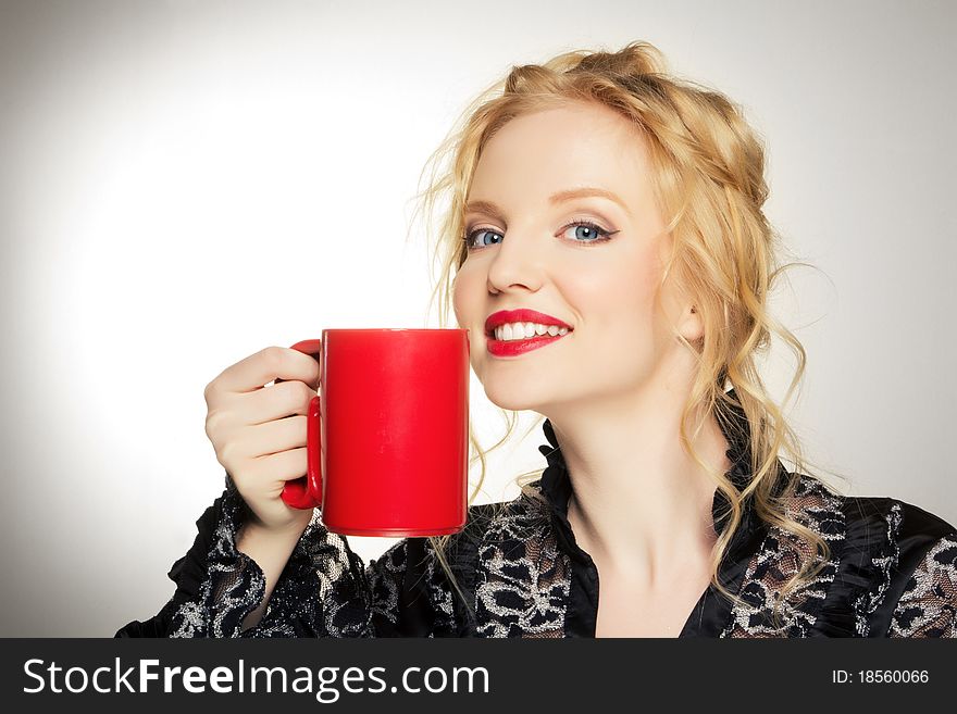 Pretty woman with a cup over white background