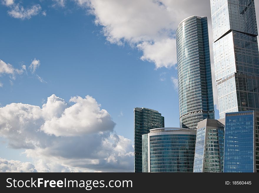 Many scyscrapers of Moscow city under blue sky with clouds