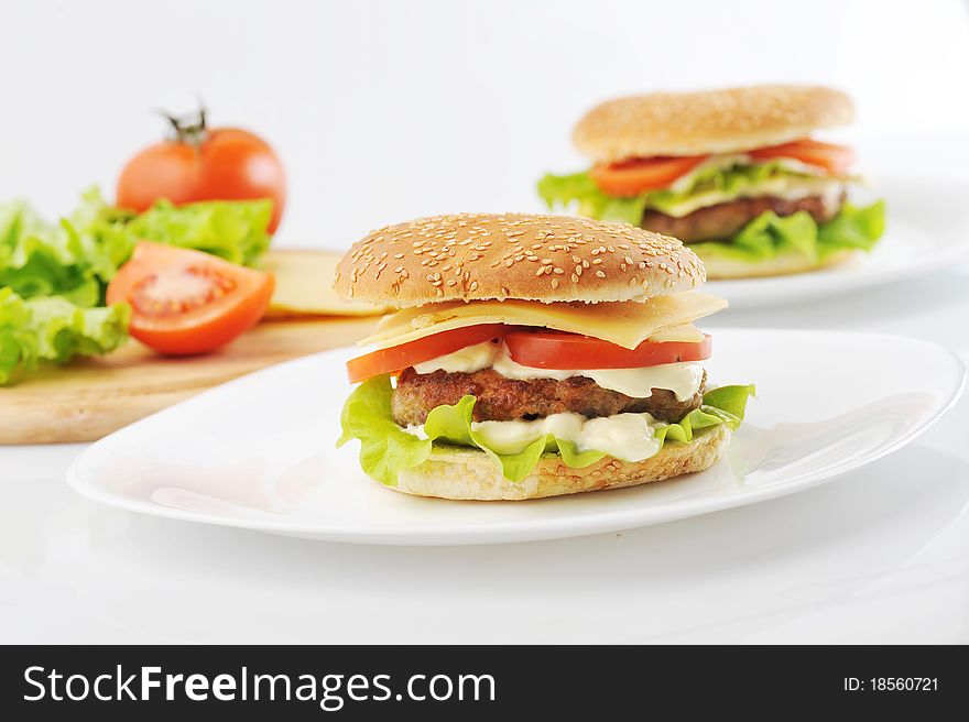 Hamburger and vegetables on white