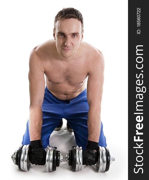 Healthy muscular bodybuilder exercising with dumbbells.White isolated. Healthy muscular bodybuilder exercising with dumbbells.White isolated.