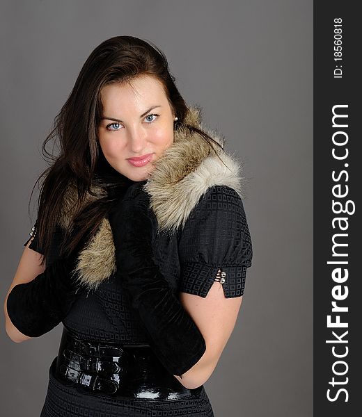 Beautiful brunette woman in elegant animal fur jacket