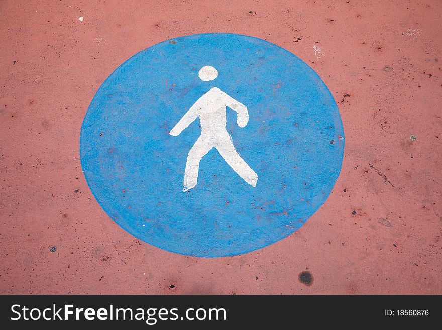 Pedestrian sign painted on the asphalt ground. Pedestrian sign painted on the asphalt ground