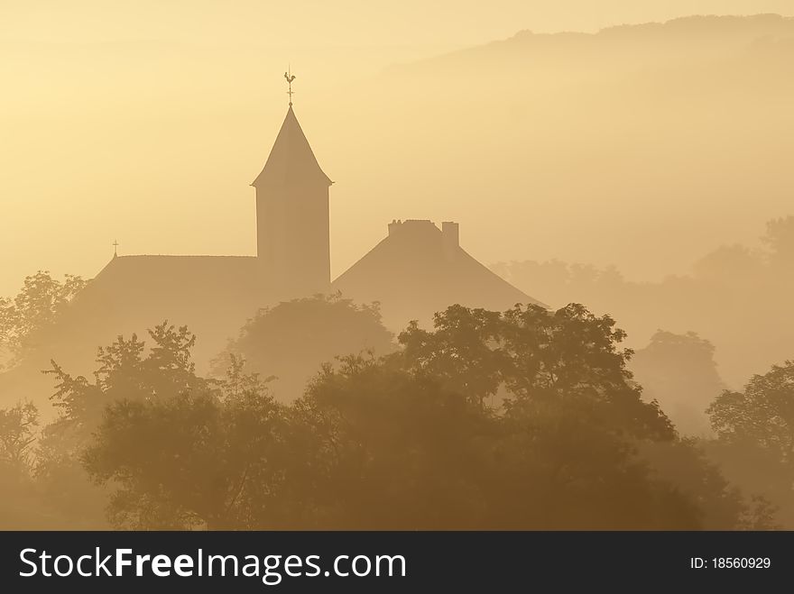 French village in the morning mist