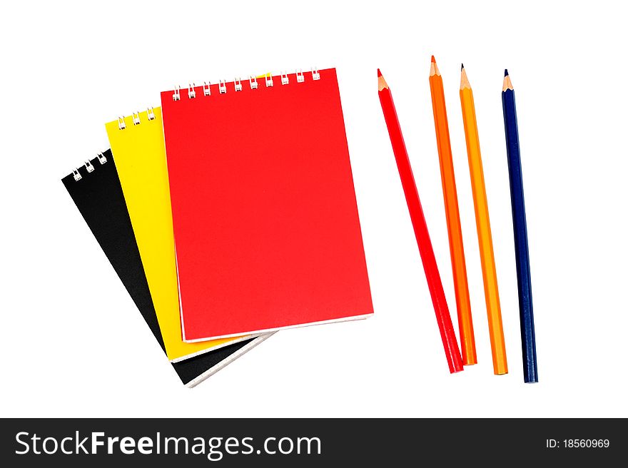 An image of notebooks with pencils on white background