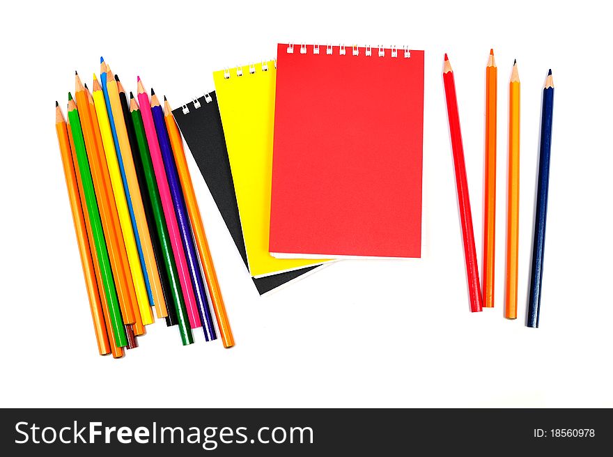 An image of notebooks with pencils on white background