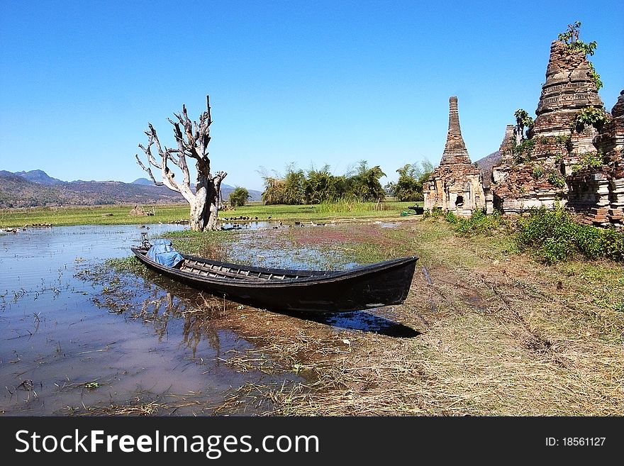 Landscape of a group of ancient buddhist stupa with a boat and dead tree in Myanmar. Landscape of a group of ancient buddhist stupa with a boat and dead tree in Myanmar