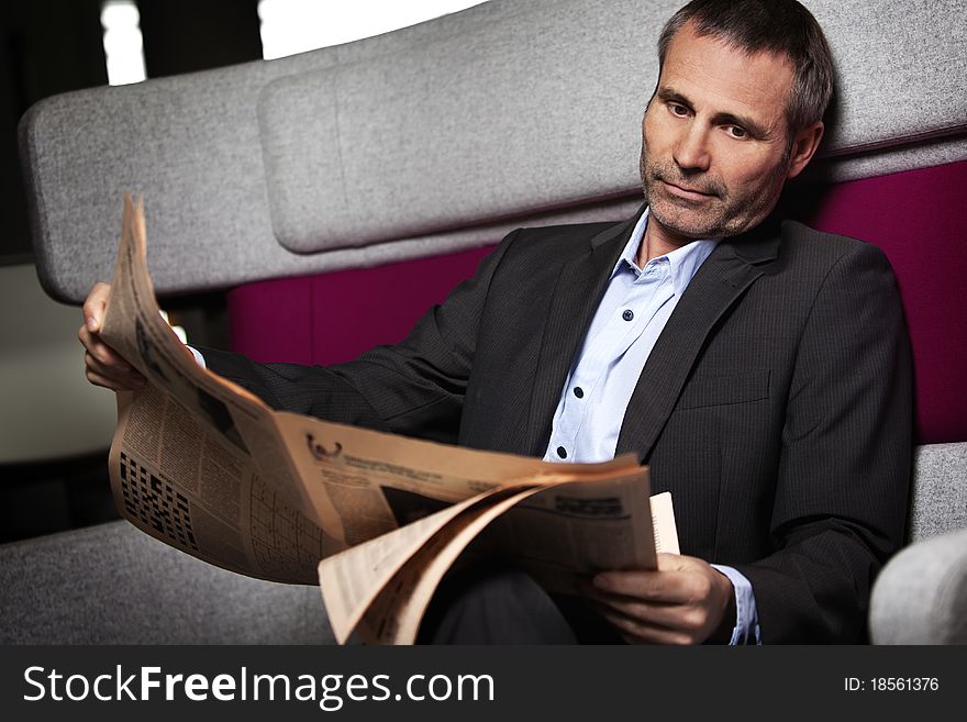 Businessman Reading Newspaper In Break.