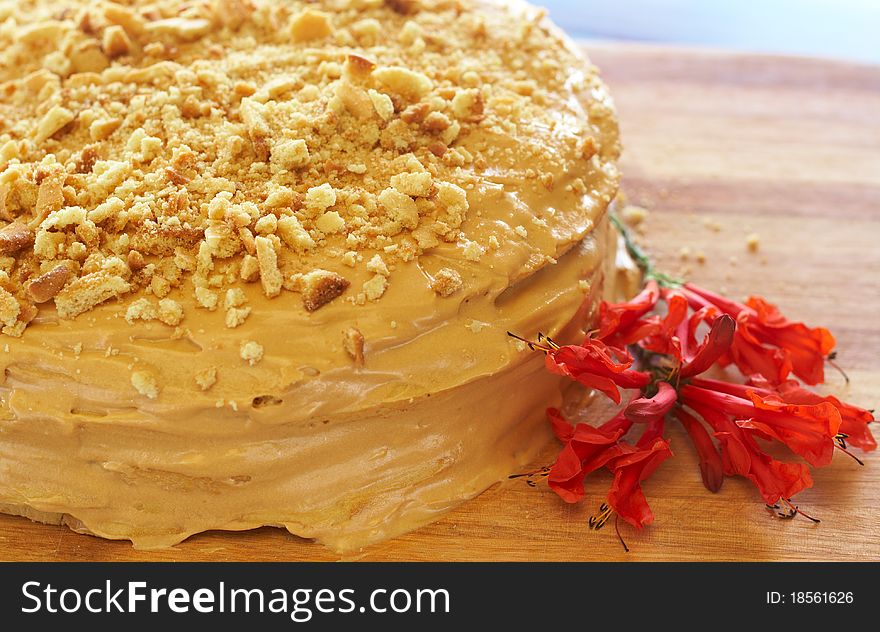 Caramel medovik cake made of honey and caramel cream, decorated with flowers